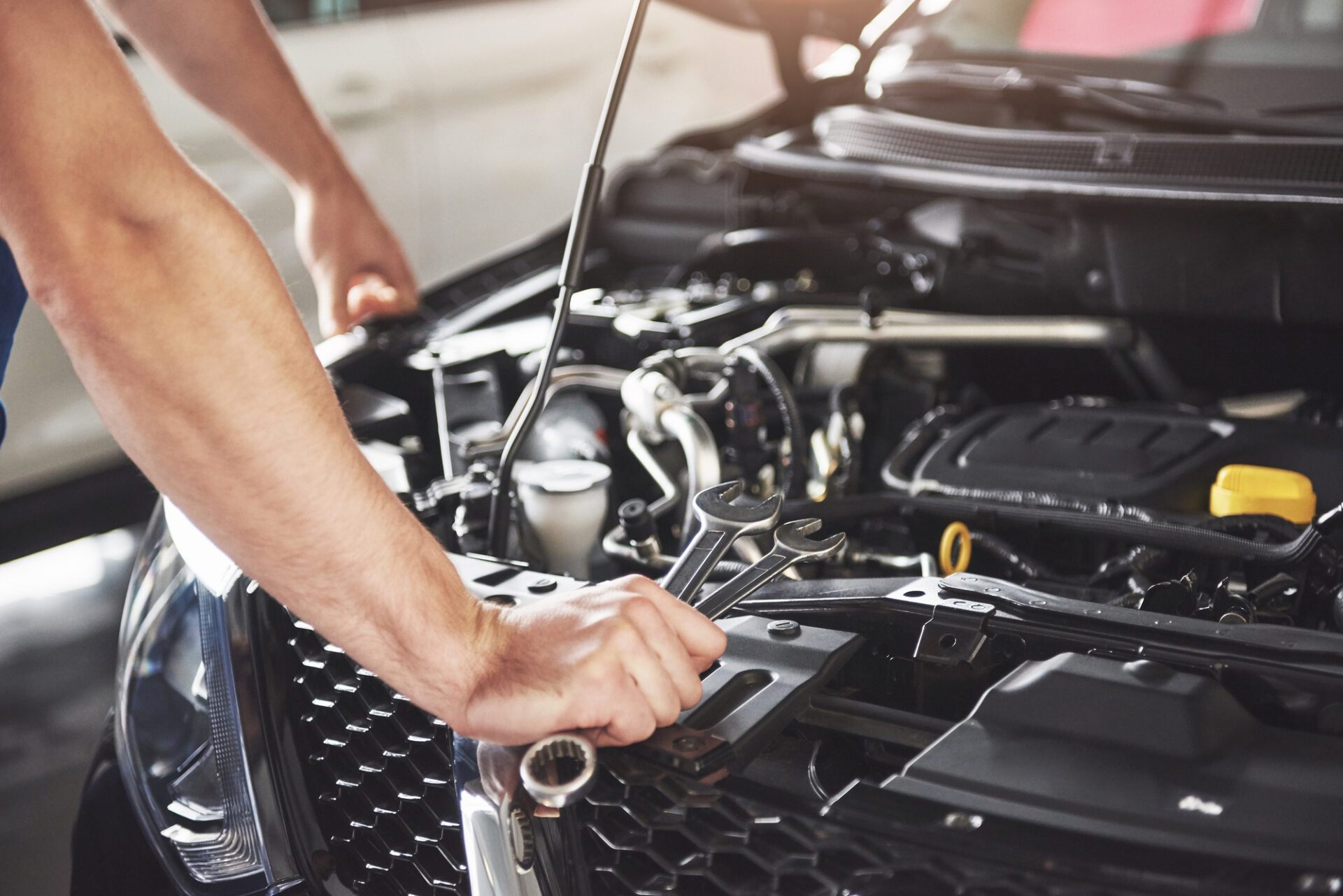 close-up-hands-unrecognizable-mechanic-doing-car-service-maintenance