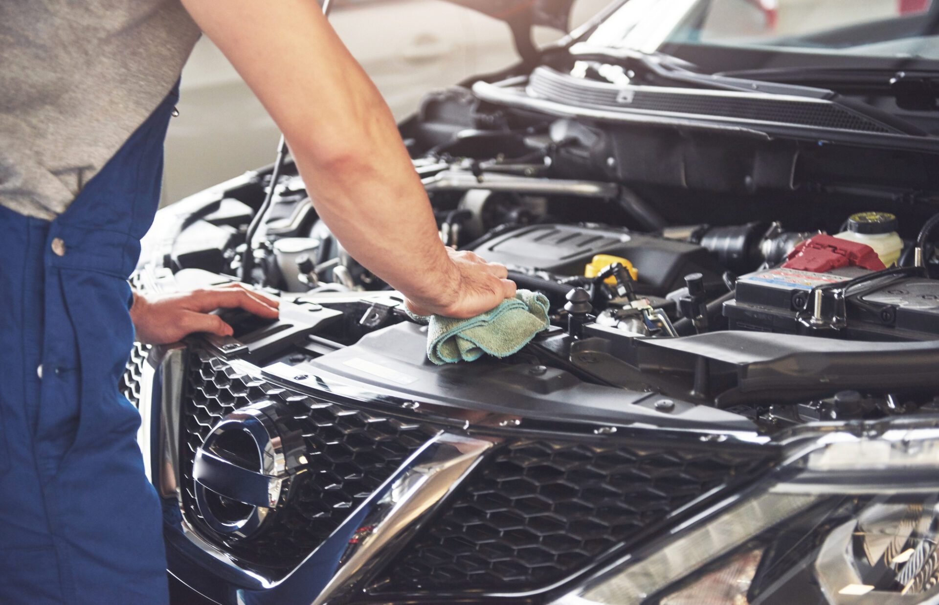 muscular-car-service-worker-repairing-vehicle