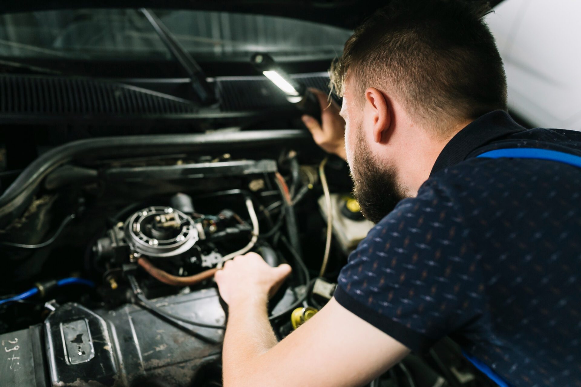 repairmen-inspecting-vehicle-engine